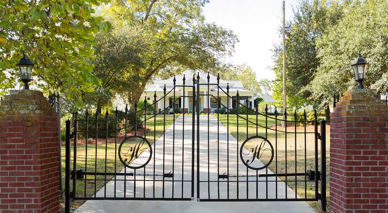 Elegant black iron entrance gate leading to Hamilton Place Events wedding venue in South Georgia.