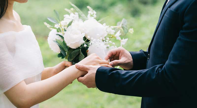 Bride and groom exchanging rings during outdoor wedding ceremony in South Georgia.