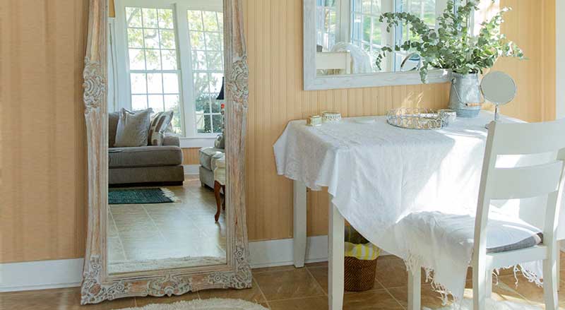 Bright and elegant bridal suite at Hamilton Place with vintage mirror, natural light, and soft neutral décor.